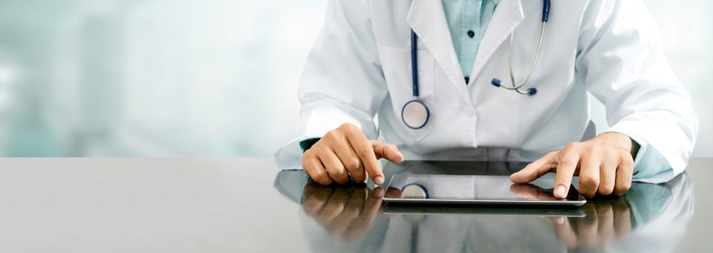 doctor with tablet - benefits of electronic health records