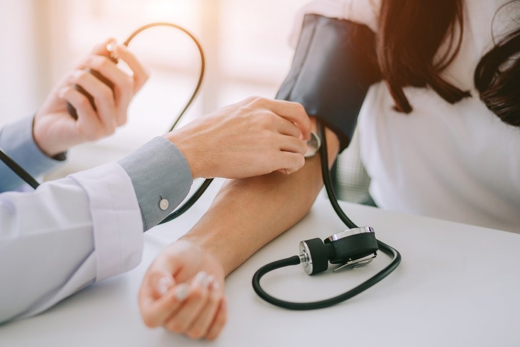 taking blood pressure - drop in primary care office visits