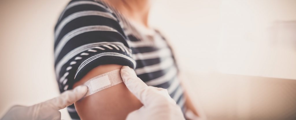 Person with a bandaid on their arm - vaccination dashboard