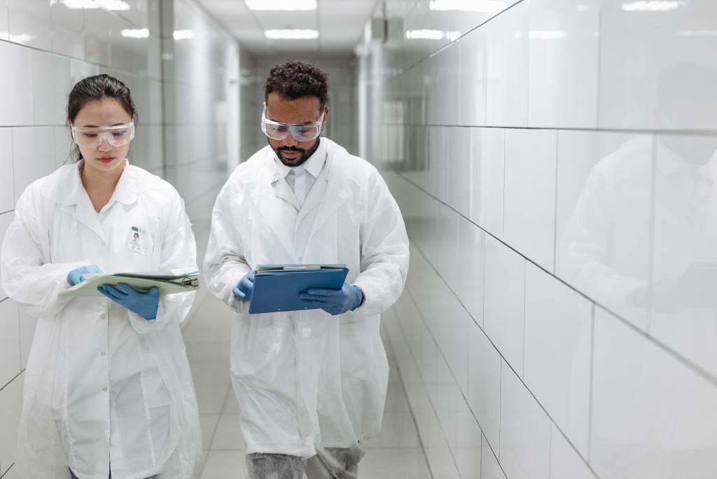 two people walking down a hospital hallway, outsourcing medical transcription